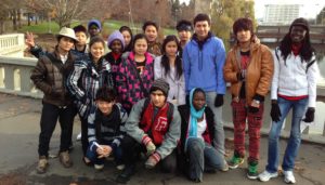 Students pose in a park in their community during a field trip in their new neighborhood. (CCSSO)