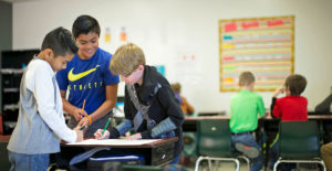 Students working together in a project-based learning classroom that uses Summit Learning as an educational resource.